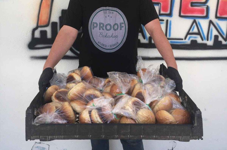 Baker holding bags of baked goods